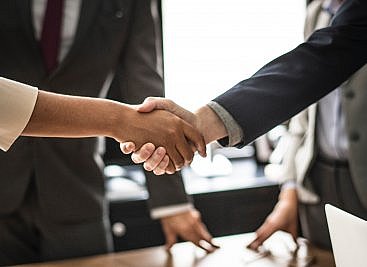 shaking hands at the end of a business meeting